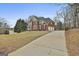 Expansive brick home with a three car garage, long drive and manicured lawn at 1133 Astoria Ln, Peachtree City, GA 30269