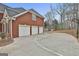 A three car garage with a basketball court adjacent to the driveway at 1133 Astoria Ln, Peachtree City, GA 30269