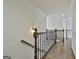 Upstairs hallway features beautiful hardwood floors and decorative wrought iron railing at 1133 Astoria Ln, Peachtree City, GA 30269
