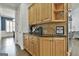Butler's pantry features granite counters, custom cabinetry and a convenient coffee bar at 1133 Astoria Ln, Peachtree City, GA 30269