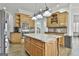 Gourmet kitchen with central island, custom cabinetry, and modern appliances at 1133 Astoria Ln, Peachtree City, GA 30269