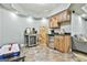 Basement kitchenette with wooden cabinets, stainless steel appliances and tiled floors at 1133 Astoria Ln, Peachtree City, GA 30269