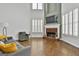 Bright living room boasts hardwood floors, a fireplace, and abundant natural light, creating a cozy and inviting space at 1133 Astoria Ln, Peachtree City, GA 30269