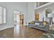 Open-concept living room featuring hardwood floors, a cozy couch, and a staircase view at 1133 Astoria Ln, Peachtree City, GA 30269
