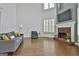 Inviting living room features a brick fireplace, vaulted ceilings, and comfortable seating, perfect for gatherings and relaxation at 1133 Astoria Ln, Peachtree City, GA 30269