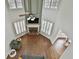 Open-concept living room with a fireplace, large windows, and high ceilings with fan at 1133 Astoria Ln, Peachtree City, GA 30269