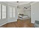 Spacious main bedroom has a tray ceiling, ceiling fan, plantation shutters, and hardwood floors at 1133 Astoria Ln, Peachtree City, GA 30269