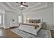 Spacious main bedroom has a tray ceiling, ceiling fan and plantation shutters at 1133 Astoria Ln, Peachtree City, GA 30269