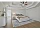 Spacious main bedroom with hardwood floors and tray ceiling is adjacent to main bath at 1133 Astoria Ln, Peachtree City, GA 30269