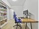 Bright home office with modern desk, built-in shelving, and laminate flooring at 1133 Astoria Ln, Peachtree City, GA 30269