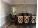 Formal dining room showcasing an elegant chandelier, a decorative rug, and seating for six around a wooden table at 135 Lucky Leaf Pl, Fayetteville, GA 30214