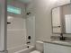 Bathroom with granite countertop, modern fixtures, and a white tub with shower at 240 Jay Trl, Fayetteville, GA 30215