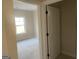 Sunlit bedroom showing a walk-in closet and neutral color, and hardwood floors at 240 Jay Trl, Fayetteville, GA 30215