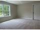 Bedroom features neutral walls, carpeting, and a window for natural light and outdoor views at 240 Jay Trl, Fayetteville, GA 30215