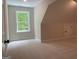 Large bonus room features natural light, and neutral carpeting for a cozy retreat at 240 Jay Trl, Fayetteville, GA 30215