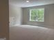 Bonus room with a bright window, neutral carpeting, and a closet door for flexible living space at 240 Jay Trl, Fayetteville, GA 30215