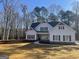 Charming two-story home with a manicured lawn, a tasteful mix of siding and stone accents, and dark shutters at 240 Jay Trl, Fayetteville, GA 30215