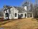 Rear exterior view of a gray home with a covered porch and winter lawn at 240 Jay Trl, Fayetteville, GA 30215