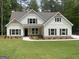 Charming two-story home with white siding, dark shutters, and manicured front lawn at 240 Jay Trl, Fayetteville, GA 30215