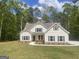Charming two-story home with neutral siding, gray shutters, and an inviting walkway at 240 Jay Trl, Fayetteville, GA 30215