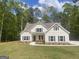 Charming two-story home with white siding, dark shutters, and manicured front lawn at 240 Jay Trl, Fayetteville, GA 30215