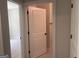 Hallway view into a carpeted bedroom with a white door and neutral paint at 240 Jay Trl, Fayetteville, GA 30215