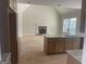 An open kitchen flows into the living room, featuring a fireplace and kitchen island at 240 Jay Trl, Fayetteville, GA 30215