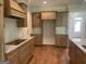 Spacious kitchen with granite countertops, hardwood floors, custom cabinets, and tiled backsplash at 240 Jay Trl, Fayetteville, GA 30215
