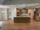 Open concept kitchen featuring hardwood floors, granite countertops and stainless faucet at 240 Jay Trl, Fayetteville, GA 30215