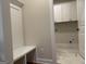 Mud room boasts a bench, storage and entry to a white laundry room at 240 Jay Trl, Fayetteville, GA 30215
