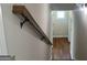 A staircase with a light wood banister leads to a room with hardwood floors and a window at 240 Jay Trl, Fayetteville, GA 30215
