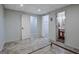 Unfinished basement area offers versatile space, with light blue walls, modern flooring, and natural lighting at 150 Gill Lane, Stockbridge, GA 30281