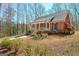 Brick home with a welcoming front porch, complemented by mature trees and landscaping at 150 Gill Ln, Stockbridge, GA 30281