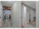 View of the unfinished basement with a chair, refrigerator, and brick wall at 150 Gill Ln, Stockbridge, GA 30281