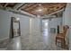View of the unfinished basement with a chair, mirror, doors, and a white wall at 150 Gill Ln, Stockbridge, GA 30281