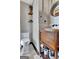 Stylish powder room featuring wood vanity, decorative mirror, and modern fixtures at 150 Gill Ln, Stockbridge, GA 30281