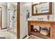 Rustic bathroom featuring a wooden vanity and a glass-enclosed shower at 150 Gill Ln, Stockbridge, GA 30281