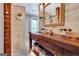 Rustic bathroom featuring a wood vanity, dual sinks, and charming decor for a spa-like experience at 150 Gill Ln, Stockbridge, GA 30281
