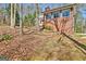 Brick home with large windows reflecting the trees in a natural setting at 150 Gill Ln, Stockbridge, GA 30281