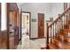 Hallway with wood staircase showcasing access to bathroom and rooms and highlighting natural light at 150 Gill Ln, Stockbridge, GA 30281