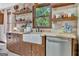 Charming kitchen features stone walls, wood cabinets, a farm sink, and floating shelves at 150 Gill Ln, Stockbridge, GA 30281
