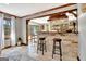 Bright living space features tiled floor, bar seating, and an open view to the kitchen at 150 Gill Ln, Stockbridge, GA 30281