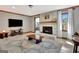 Spacious living room boasts a cozy fireplace, TV, wood accents, and natural light from the window at 150 Gill Ln, Stockbridge, GA 30281