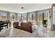 Inviting living room featuring a leather sofa and grand piano, enhanced by large windows and scenic views at 150 Gill Ln, Stockbridge, GA 30281
