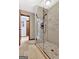 Bright shower with glass door and marble tile at 150 Gill Ln, Stockbridge, GA 30281