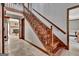 Beautiful wooden staircase with detailed banister and tile flooring in entry hall at 150 Gill Ln, Stockbridge, GA 30281
