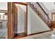 View of the wooden staircase and an open doorway in the house at 150 Gill Ln, Stockbridge, GA 30281