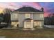 The home's back exterior features a multi-level patio perfect for outdoor living and entertaining at 2715 Ivey Crossing Trl, Cumming, GA 30041
