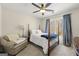 Bright bedroom with hardwood floors, ceiling fan, and large windows with views of nature at 2715 Ivey Crossing Trl, Cumming, GA 30041