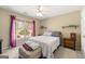 Cozy bedroom with a large window, ceiling fan, and neutral-colored walls at 2715 Ivey Crossing Trl, Cumming, GA 30041